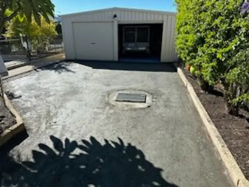 New asphalt driveway to a backyard shed