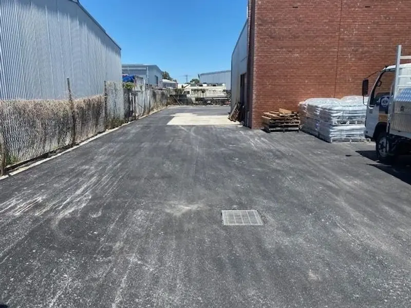 New asphalt laneway behind commercial units