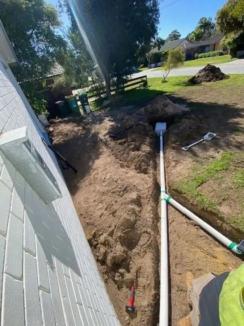 Stormwater pipe in trench connected to downpipe