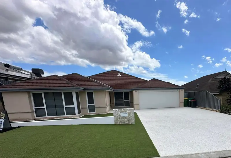 New concrete driveway and fresh lawn at a Perth home