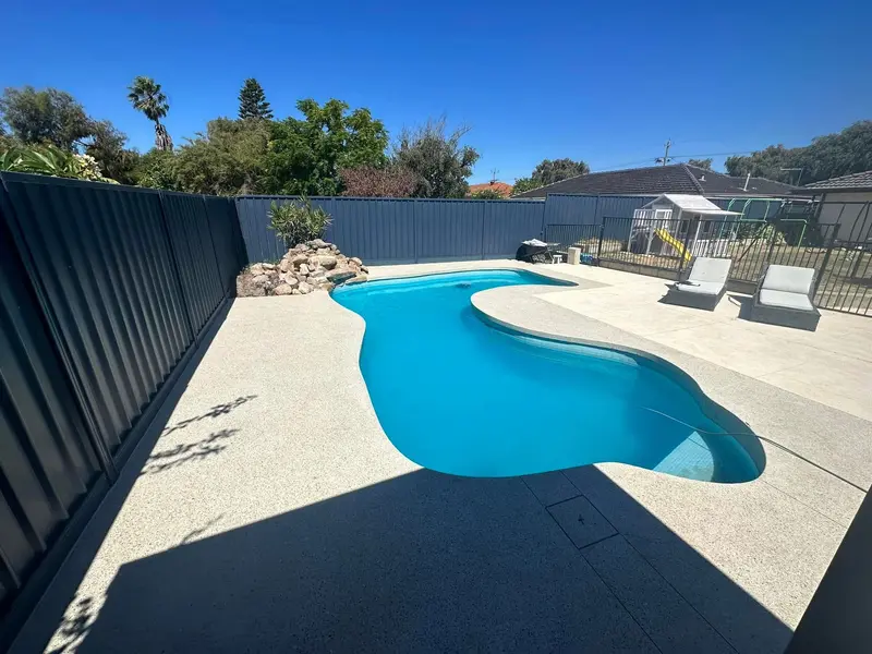 Freeform pool with exposed aggregate surround