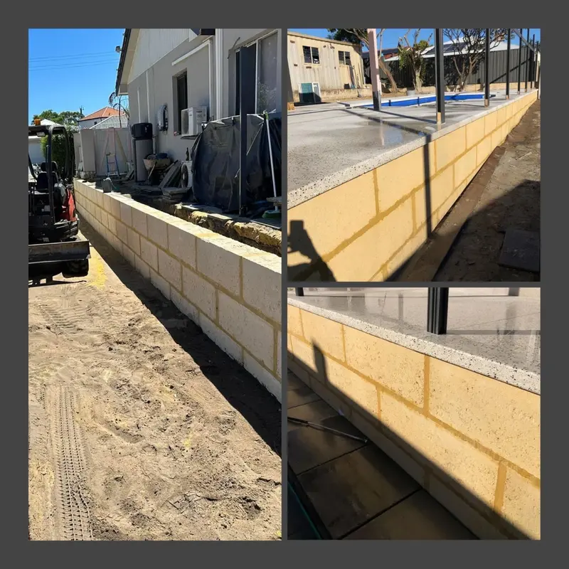 New limestone retaining wall along a fence line